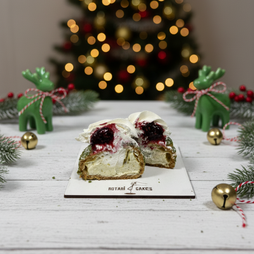 
                  
                    pistachio choux cake on a white plate with a Christmas tree in the background
                  
                