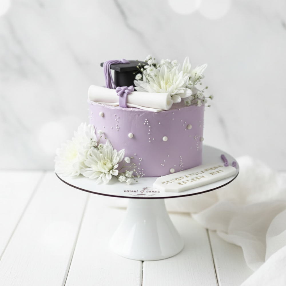 graduation cake in purple colour with flowers and diplom and hat