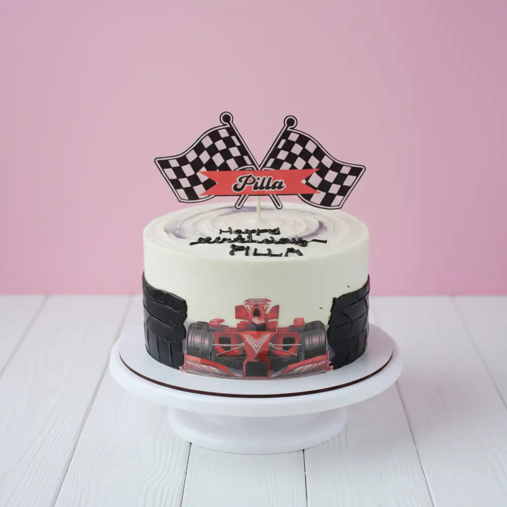 racing theme Birthday cake with checkered flag topper and tire design on a pink background