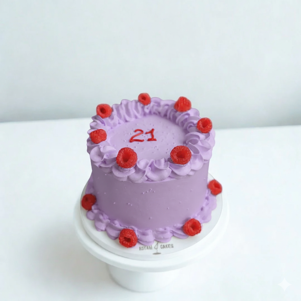 
                  
                    Purple cake with red berries on a white background
                  
                