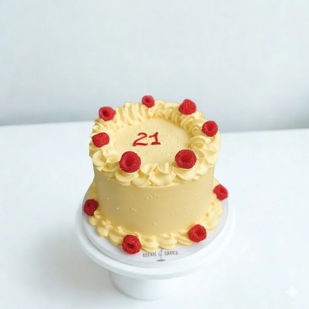 
                  
                    Small yellow cake with red berries and number 21 on a white background
                  
                