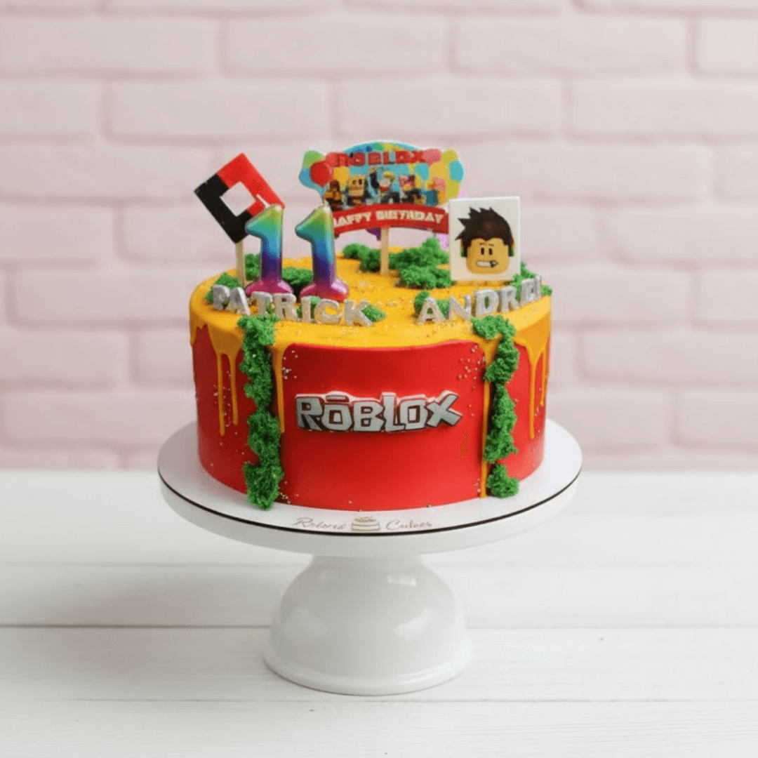 Roblox birthday cake with colorful decorations on a white stand against a light pink background