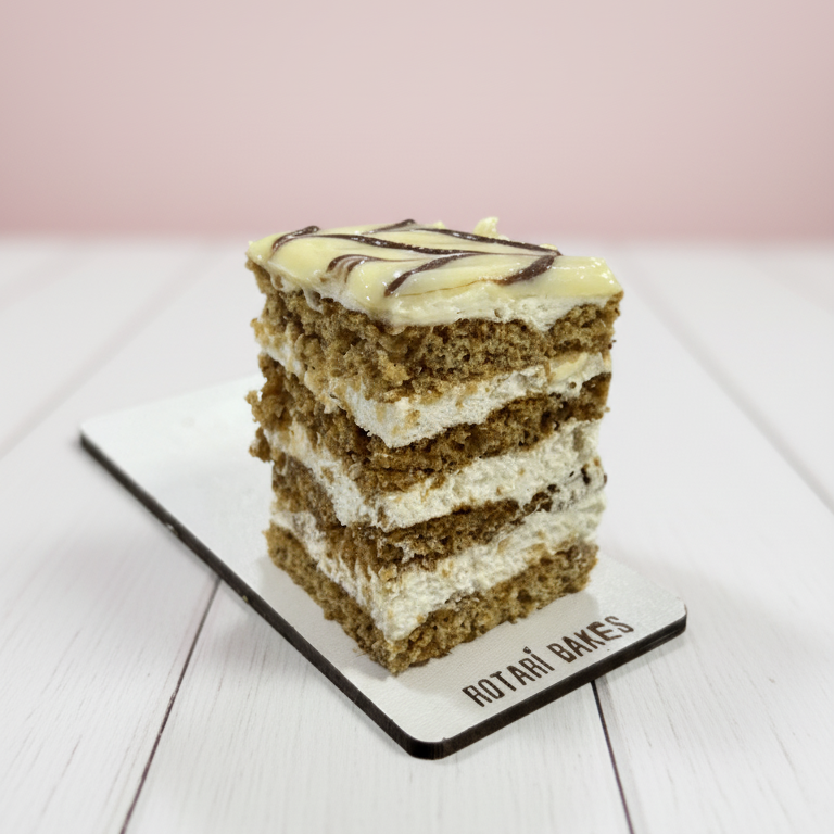 
                  
                    Layered cake on a white plate with a pink background
                  
                