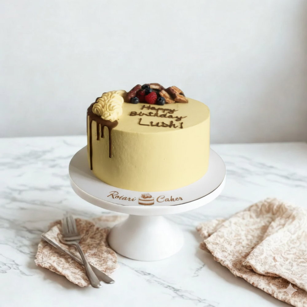 
                  
                    Gold birthday cake with fruit toppings on a white marble surface
                  
                