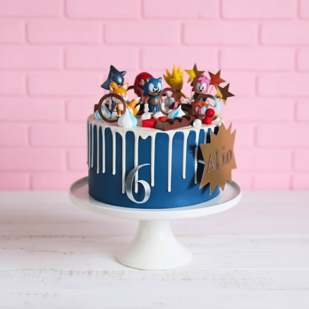 
                  
                    Blue birthday cake with sonic theme toppers 
                  
                