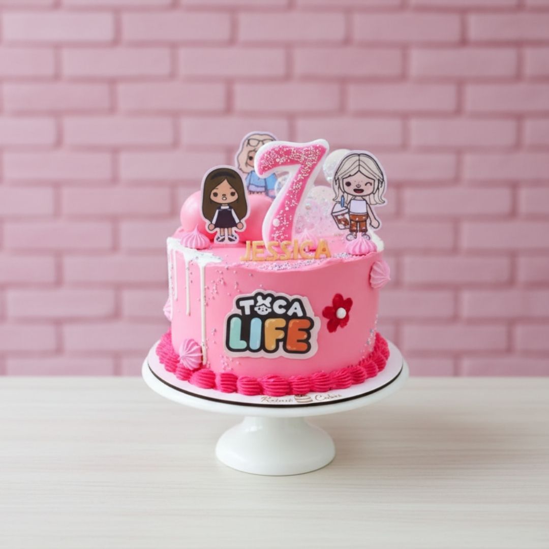 Pink birthday cake with 'Toca Life' theme and number 7 topper against a pink brick wall.