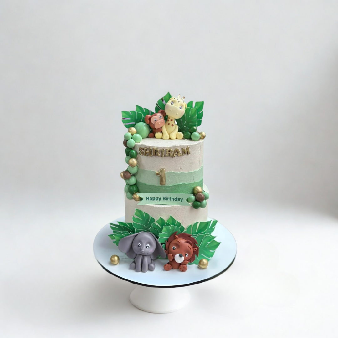 Two-tier vegan birthday cake with animal-themed decorations 