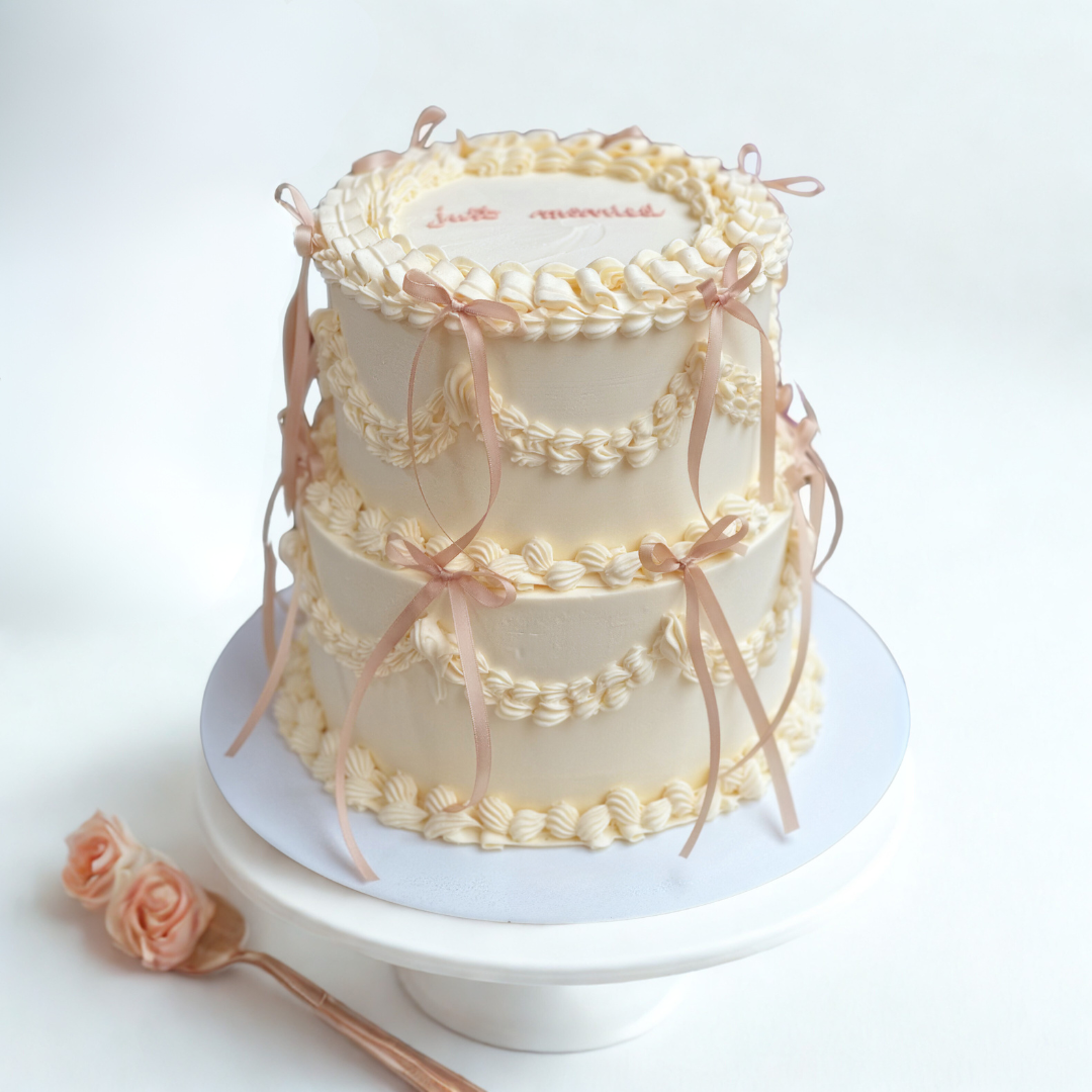 Hand-decorated vintage-style cake ideal for baby showers and bridal parties