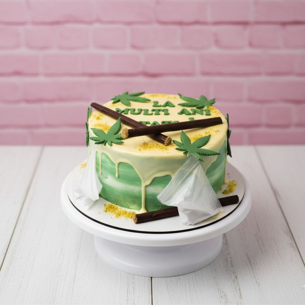 weed theme cake with decorative elements on a white stand against a pink brick wall.