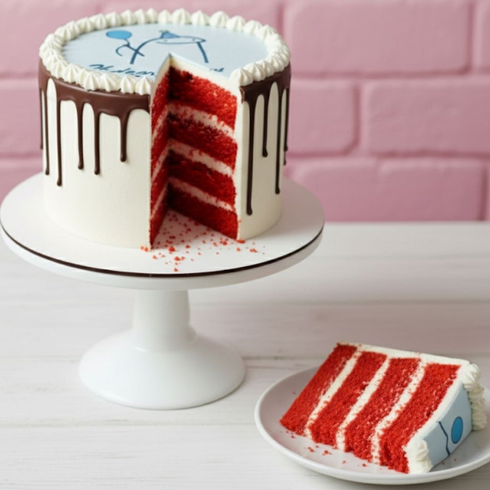 Red velvet cake with white frosting and chocolate drizzle on a white cake stand, with a slice on a plate.