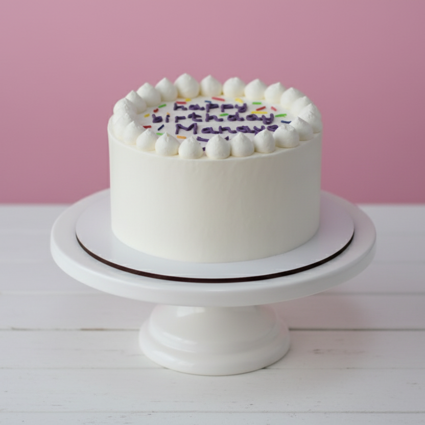 white mini birthday cake with piping and custom writing